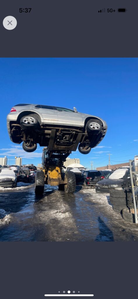 Tow truck lifting a junk car